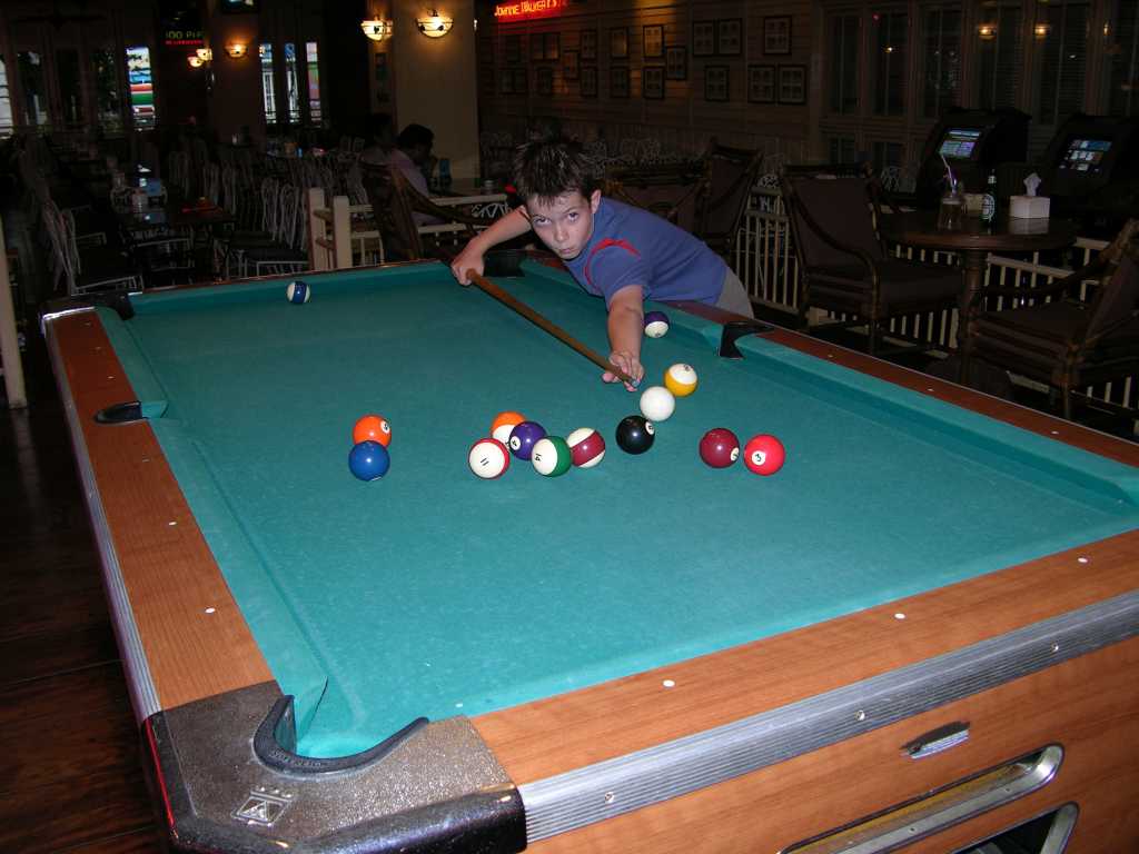 Bangkok 01 04 Buddy Lodge Playing Pool Bangkoks Buddy Lodge has its own restaurant where we had our buffet breakfast. Afterward, Peter and I played pool.